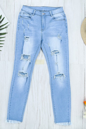 MID RISE LIGHT BLUE RIPPED JEANS